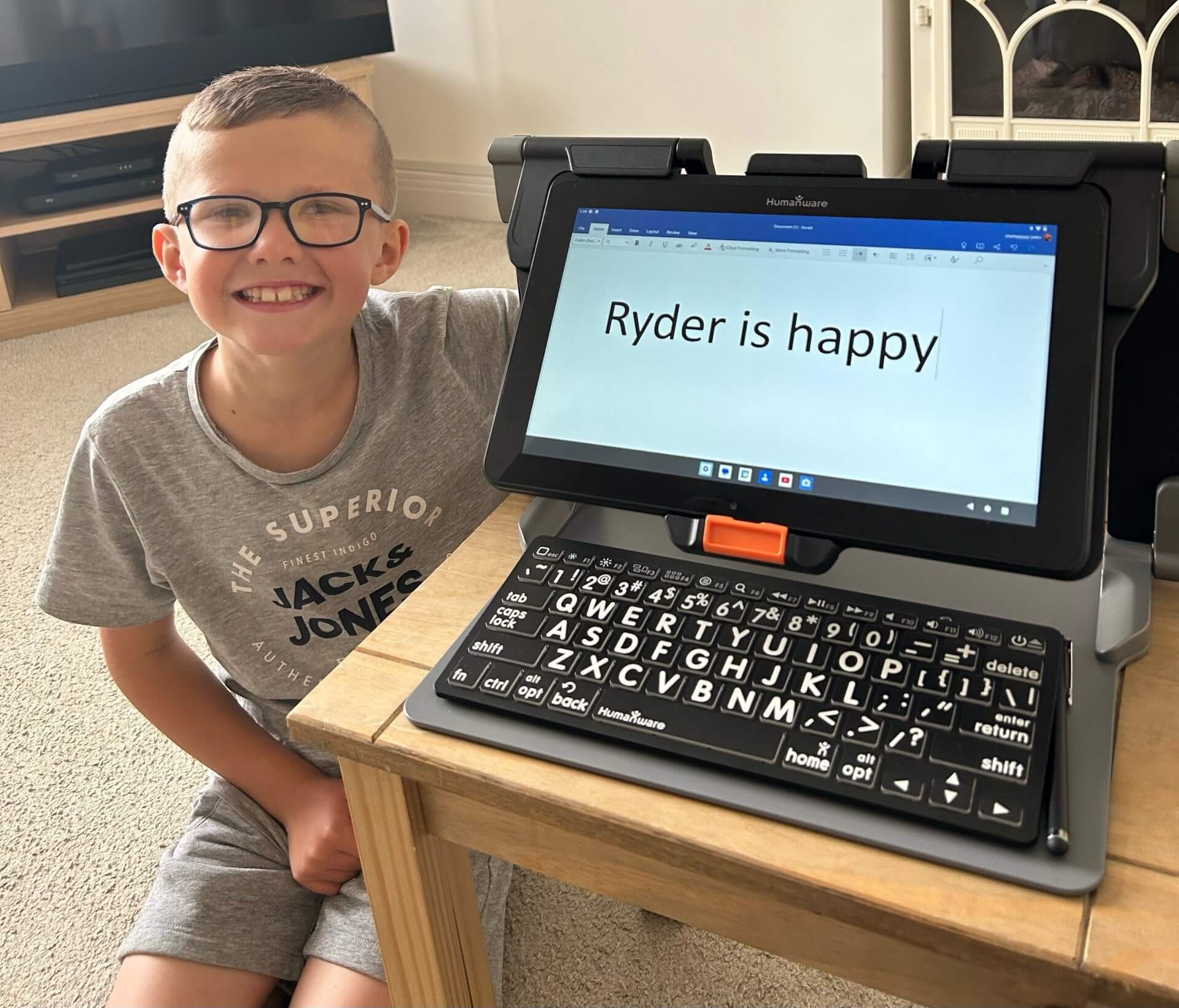 boy looking very happy with his new computer